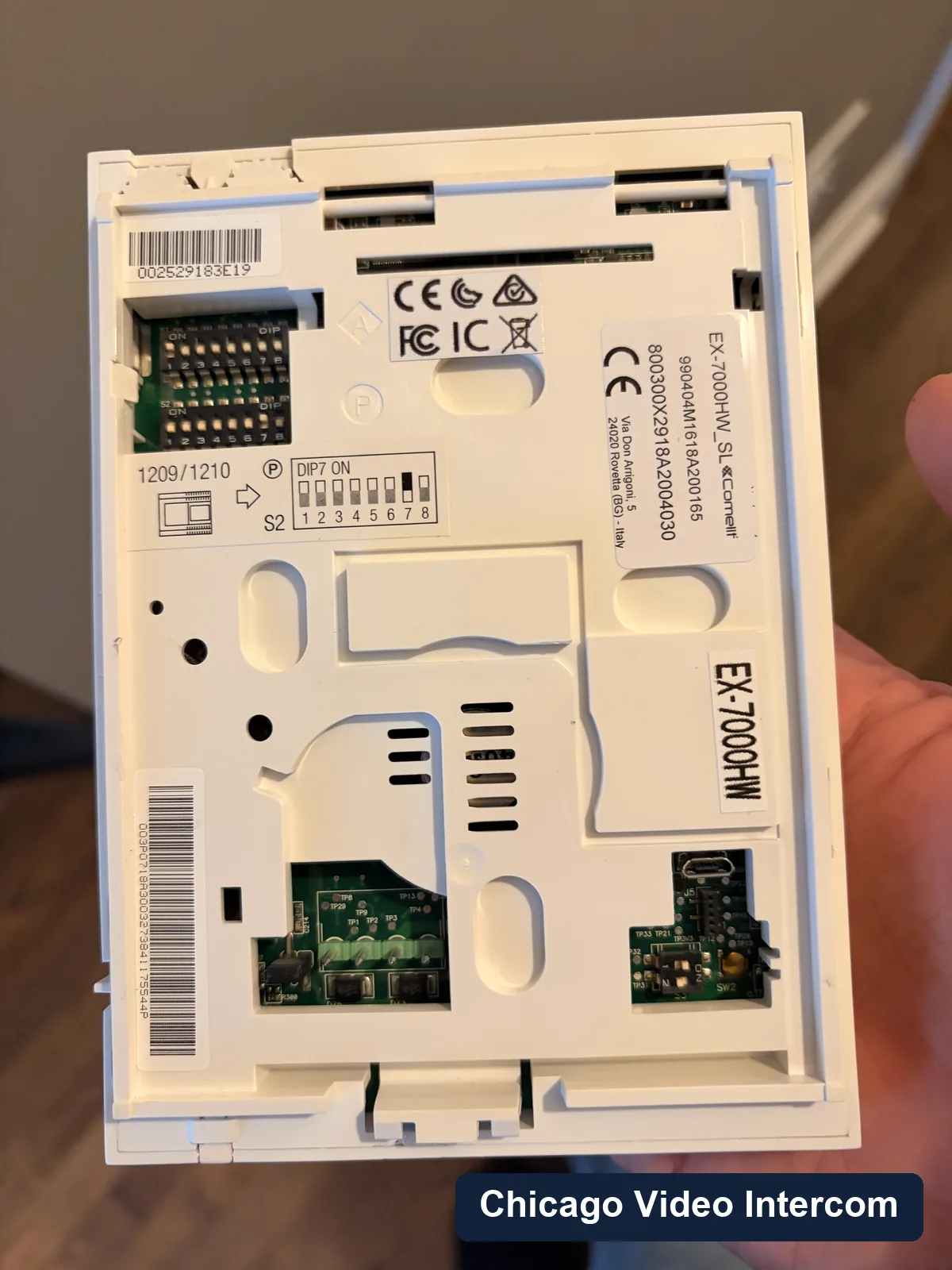 Back side of a wall-mounted intercom station with wiring