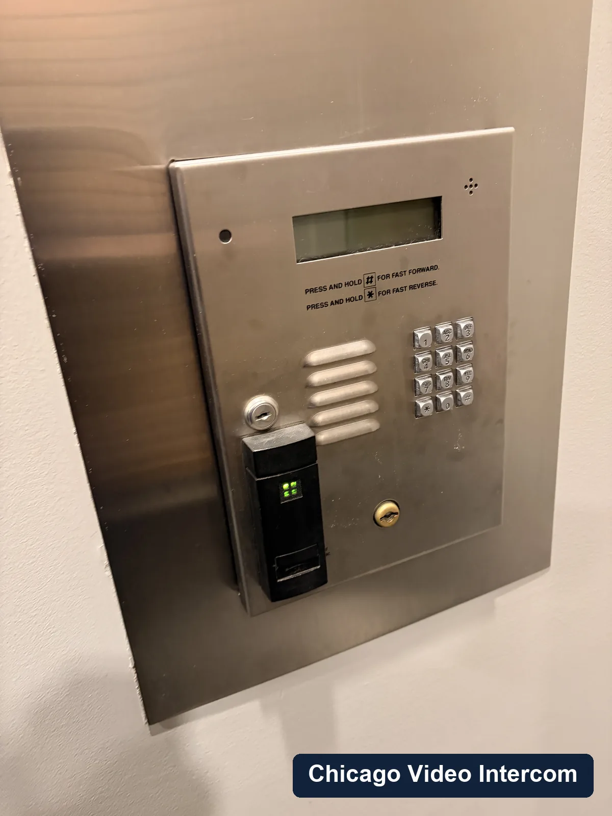 Older metal telephone entry panel with tenant buttons in Chicago