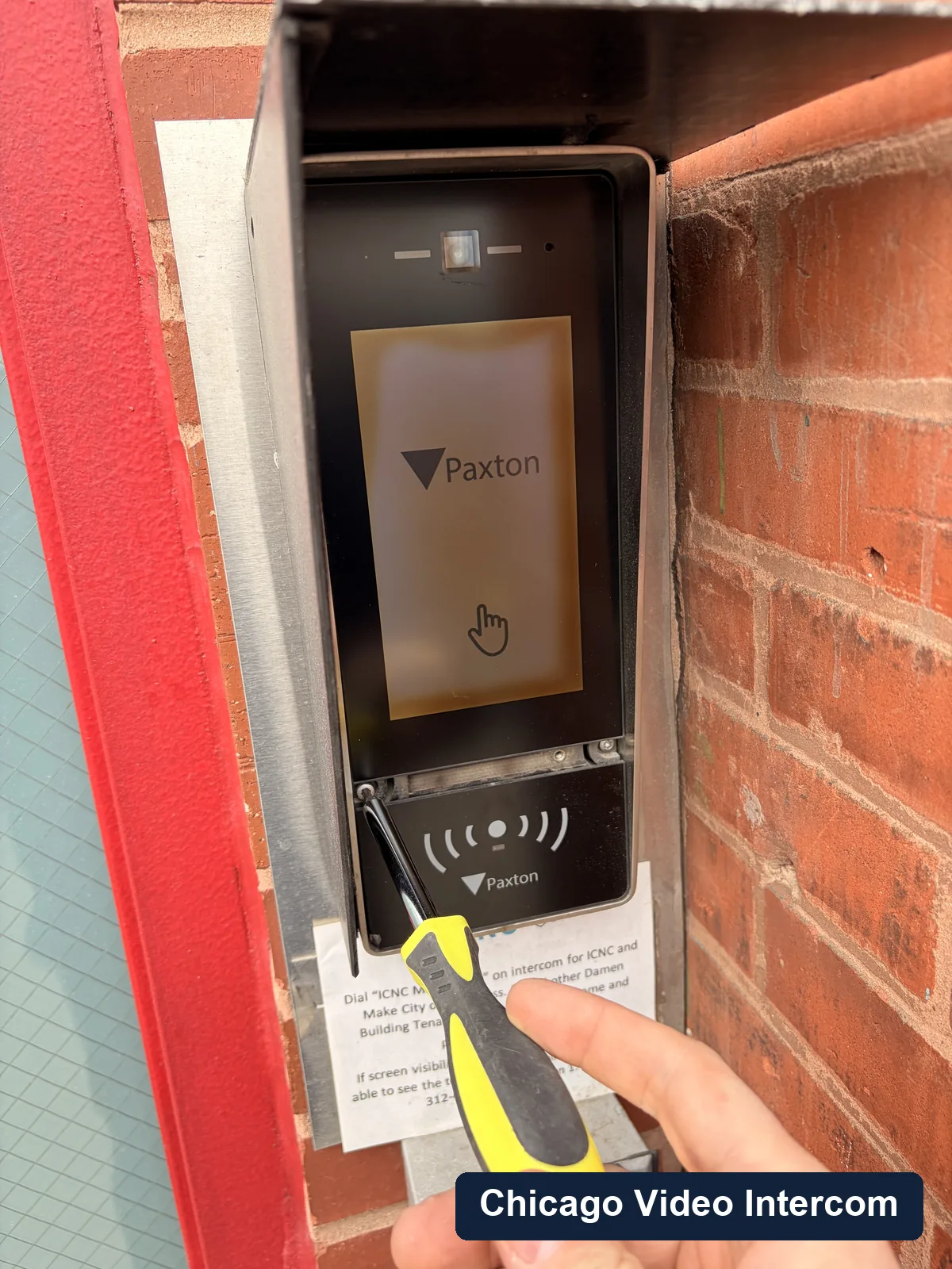 Exterior intercom panel service with tools at a Chicago entry