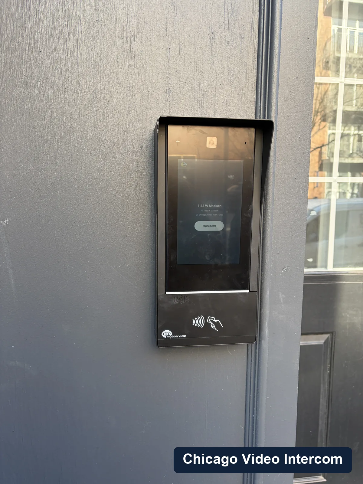 Close-up of an exterior video intercom panel at a Chicago building entrance