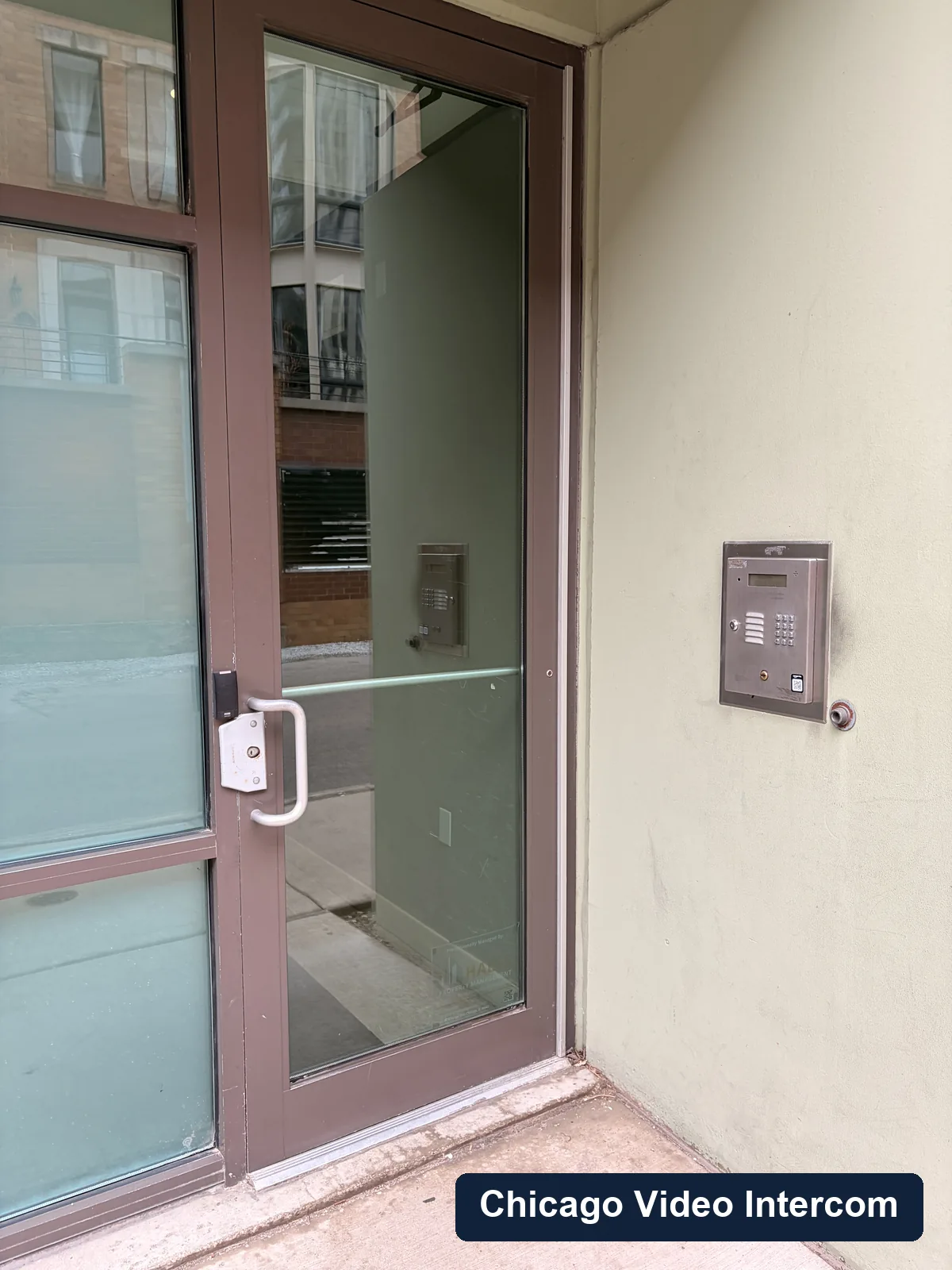 Small exterior video entry panel next to a Chicago doorway
