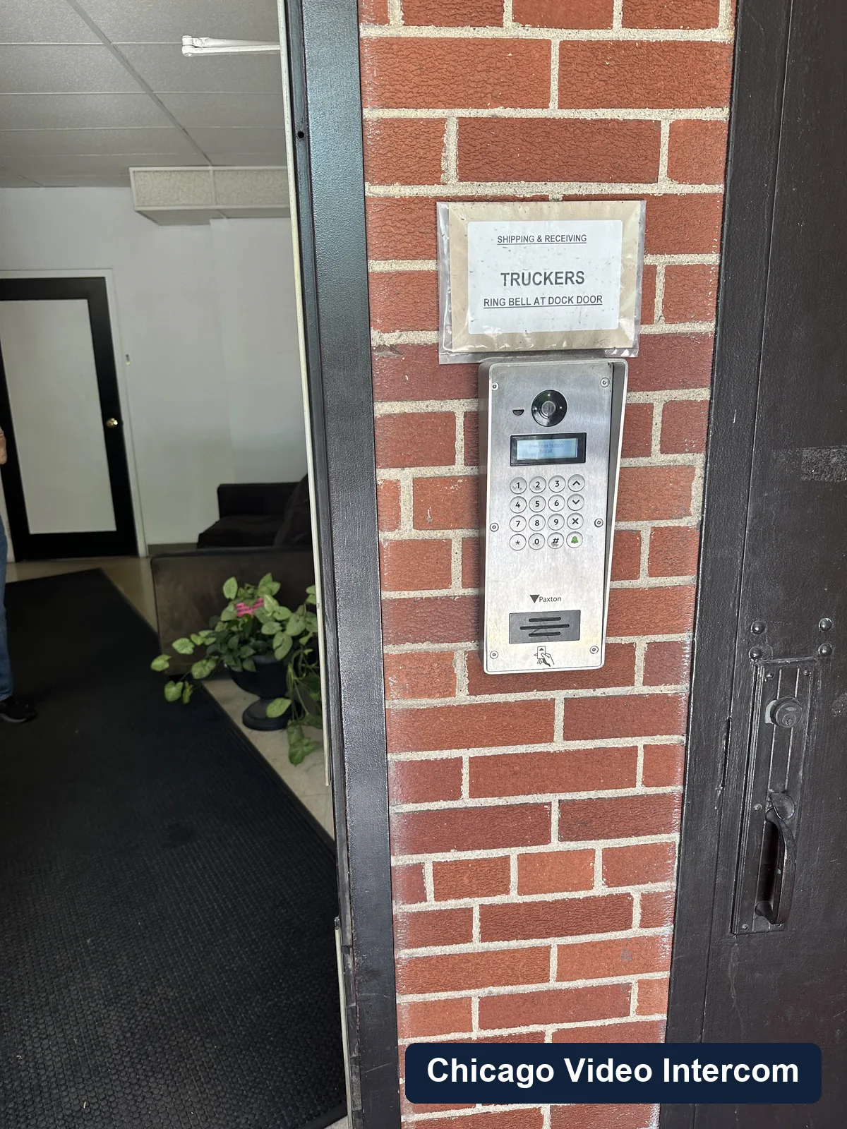 Smart door entry panel and sign at a Chicago building entrance