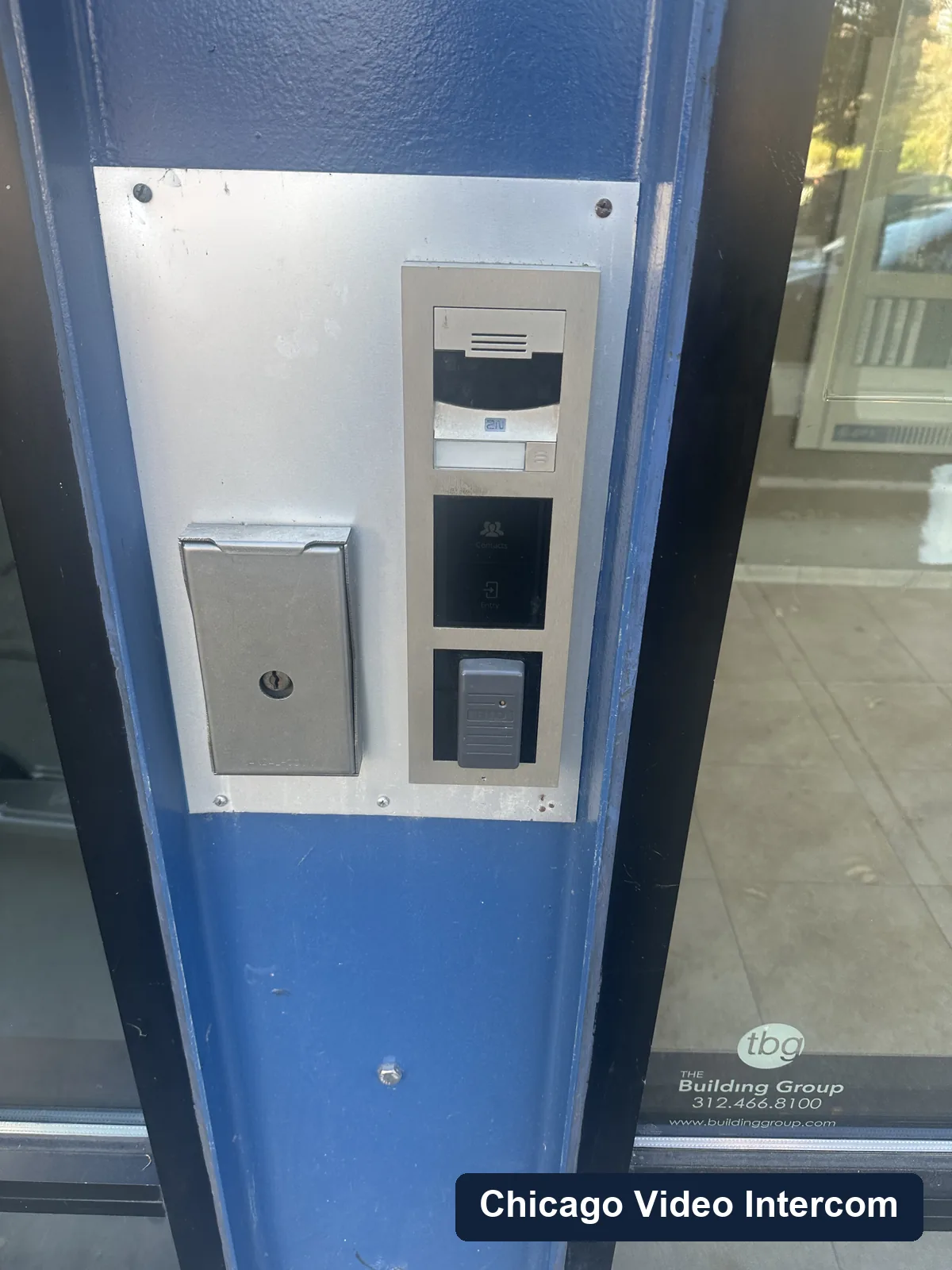 Tall video door entry panel installed at a blue Chicago storefront entrance