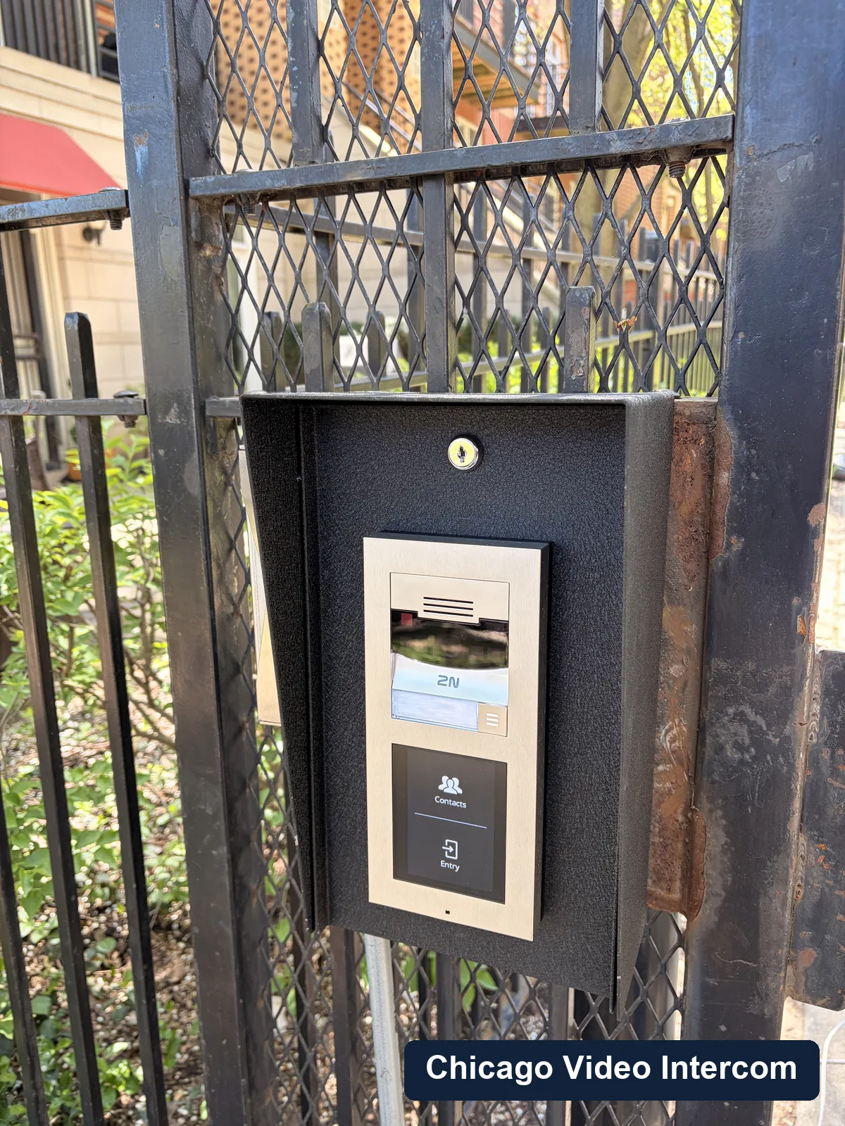 Black gate intercom panel mounted at a Chicago exterior entry