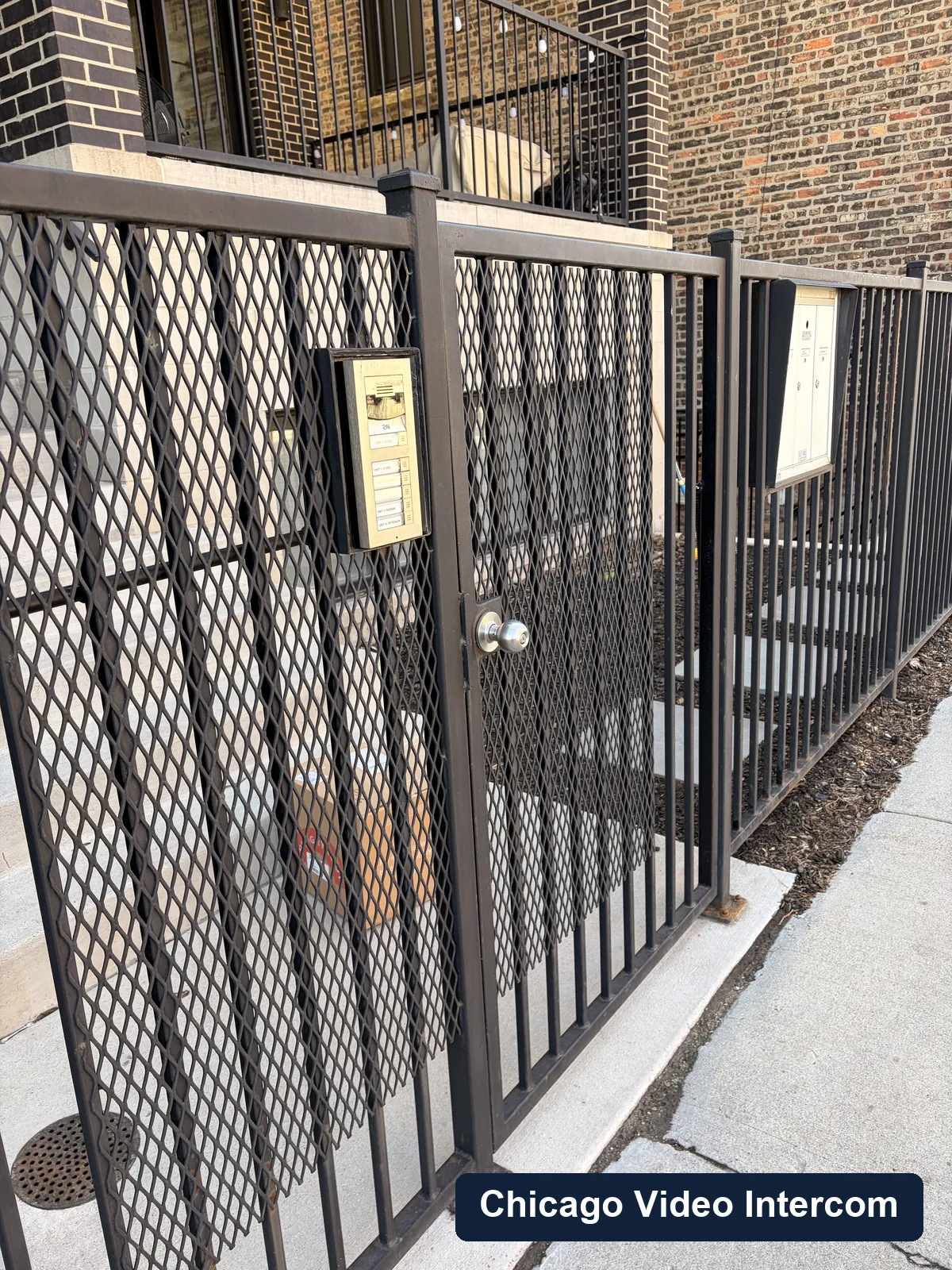 Wide view of a Chicago courtyard gate entry with intercom location