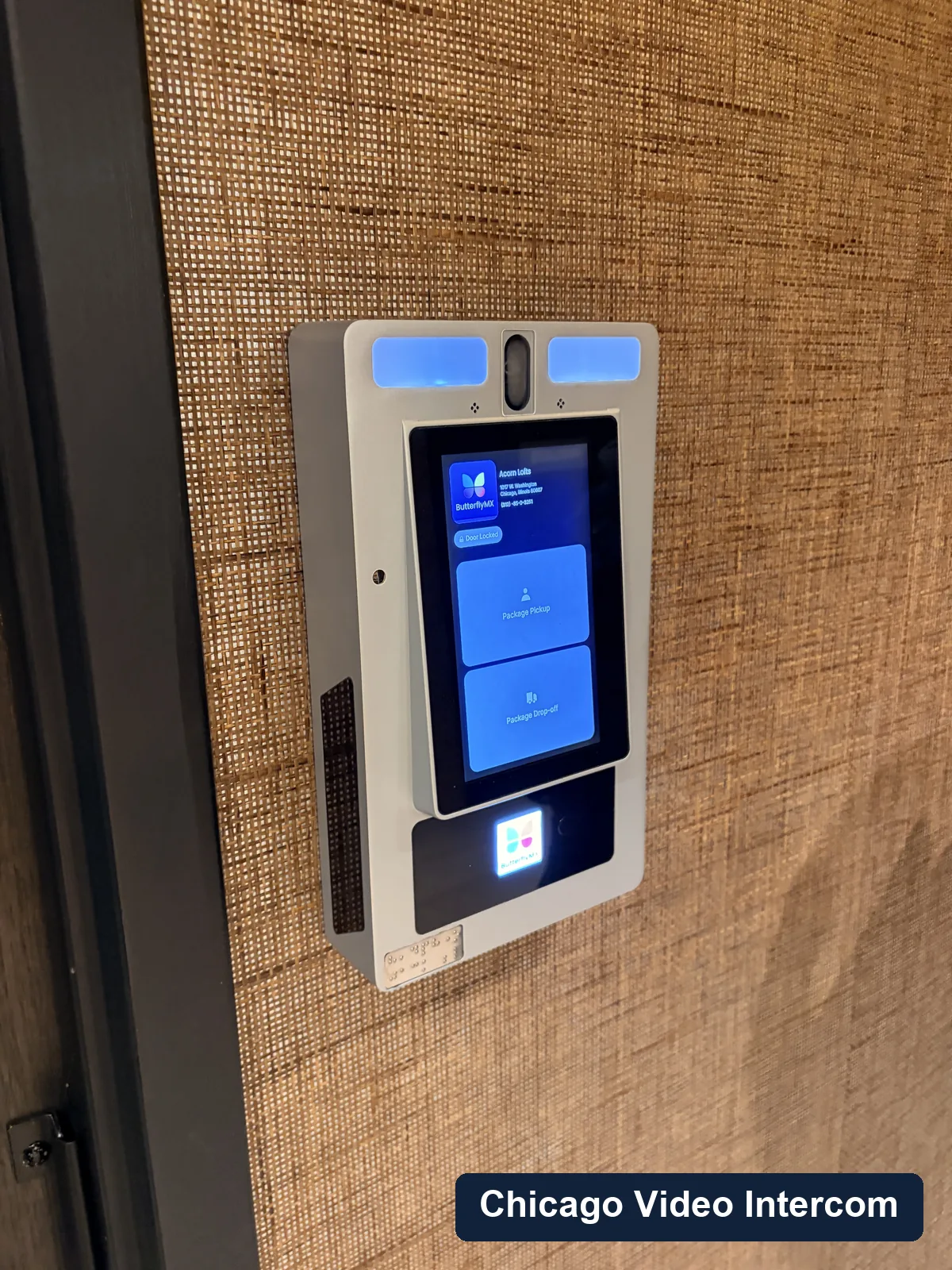 Lobby video intercom screen near a Chicago entry door