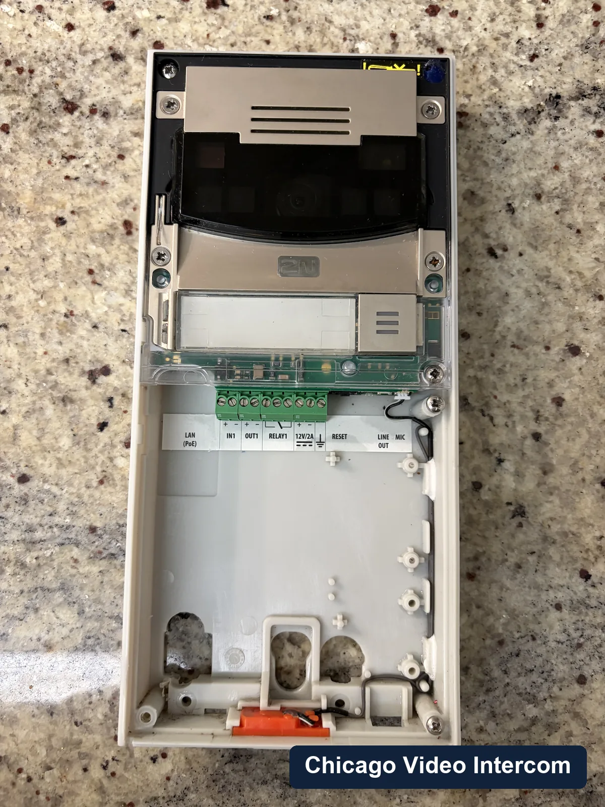Open intercom control board inside an exterior entry panel