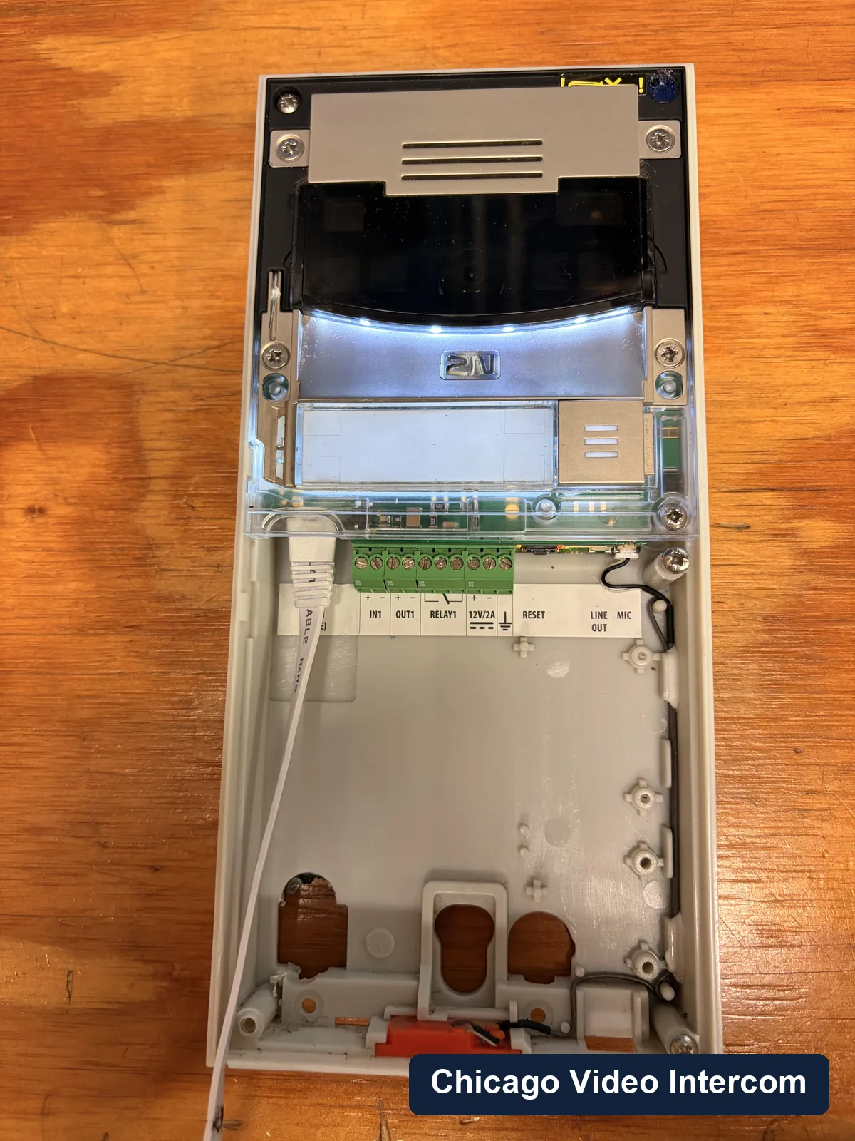 Open entry panel with wiring exposed for intercom repair