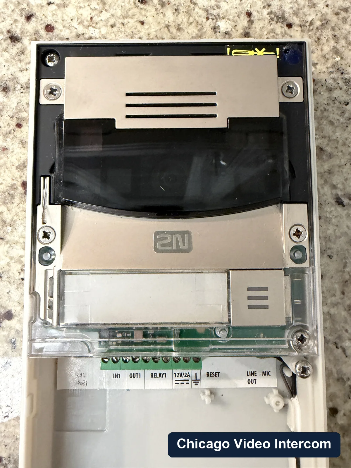 Video intercom wiring terminals inside an open entry panel